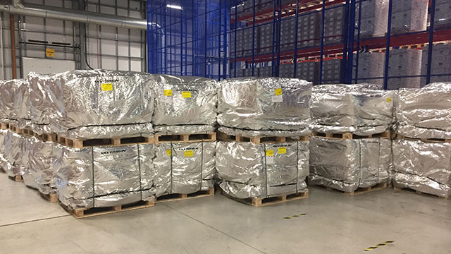 Pallets of finished pharmaceutical product wrapped in passive thermal covers